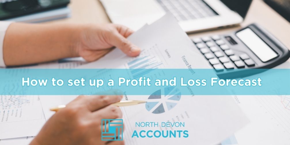 Hands reviewing financial paperwork at a desk, illustrating how to set up a profit and loss forecast with guidance from North Devon Accounts