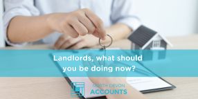 Landlord reviewing paperwork and using a calculator, illustrating what landlords should be doing now with guidance from North Devon Accounts
