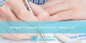 Unique Taxpayer Reference what is it Person completing tax paperwork with a calculator, illustrating what a Unique Taxpayer Reference is with guidance from North Devon Accounts