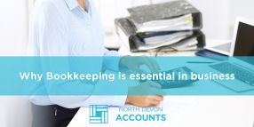Business owner holding documents in an office, illustrating why bookkeeping is essential for business with guidance from North Devon Accounts