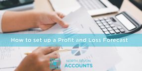 Hands reviewing financial paperwork at a desk, illustrating how to set up a profit and loss forecast with guidance from North Devon Accounts