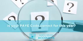 Magnifying glass over question marks, illustrating checking if your PAYE code is correct with guidance from North Devon Accounts